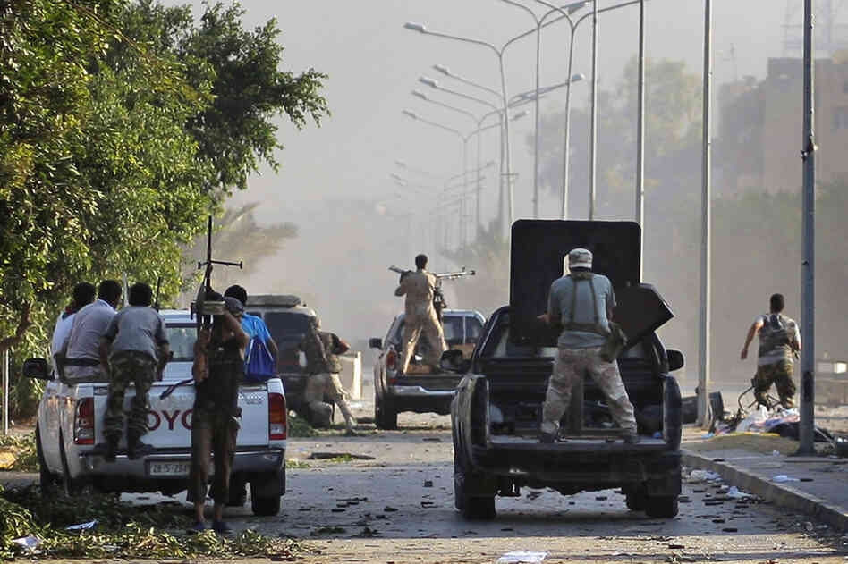 Rebel fighters advance toward the frontline in the Abu Salim district. 