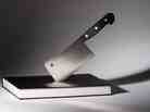 A butcher knife stuck in a book A butcher knife stuck in a book