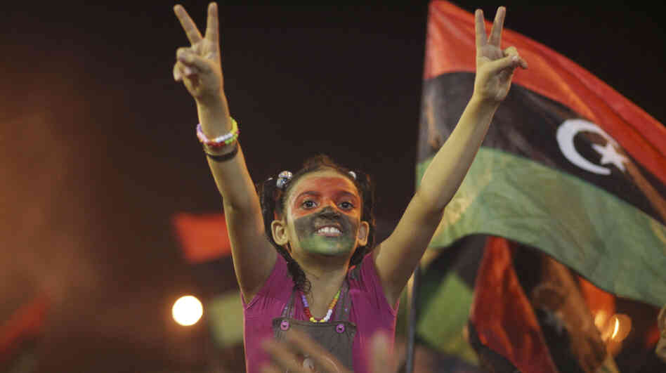 A young Libyan in Benghazi celebrates Tuesday over news that Moammar Gadhafi's rule appears to be at an end. The U.S. says it is prepared to unfreeze Libyan assets quickly and make them available to a new government. A young Libyan in Benghazi celebrates Tuesday over news that Moammar Gadhafi's rule appears to be at an end. The U.S. says it is prepared to unfreeze Libyan assets quickly and make them available to a new government.