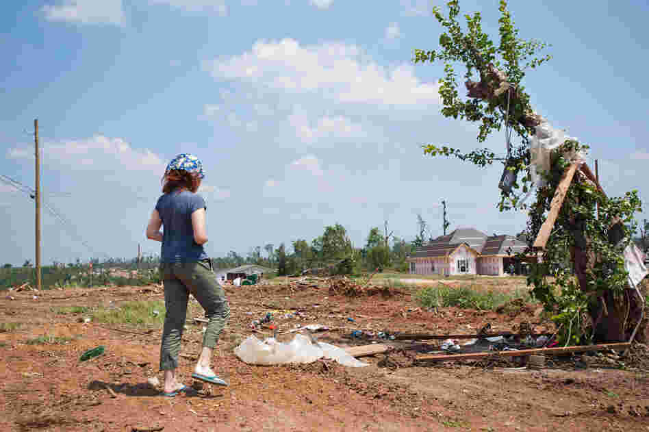 Neko Case contemplates a tree that has become home to a car fender, now a landmark in town."The randomness of the destruction ... you almost can't look at it through any context. It's not like there was just one bad guy and his house got crushed and it all makes sense. My brain wants to ask why." – Jim James