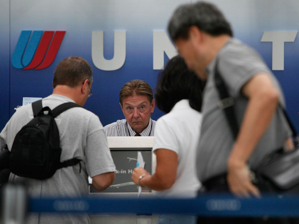 Passengers wait in line at the United Airlines terminal at Chicago's O'Hare airport in 2009 after a computer malfunction caused long delays and the cancellation of some United flights.
