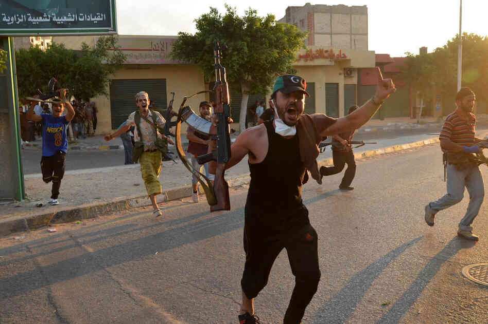 Libyan rebels celebrate after gaining positions against regime forces in Zawiya on Aug.19. 