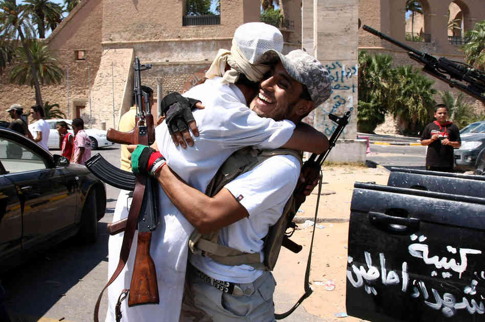 Libyan rebel fighters celebrate in the newly named Martyr's Square, formerly known as Green Square, in Tripoli. 