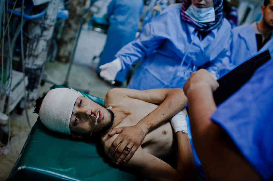 A Libyan rebel fighter receives medical attention after being brought in with a gunshot wound to his head at the Tripoli Central Hospital. 
