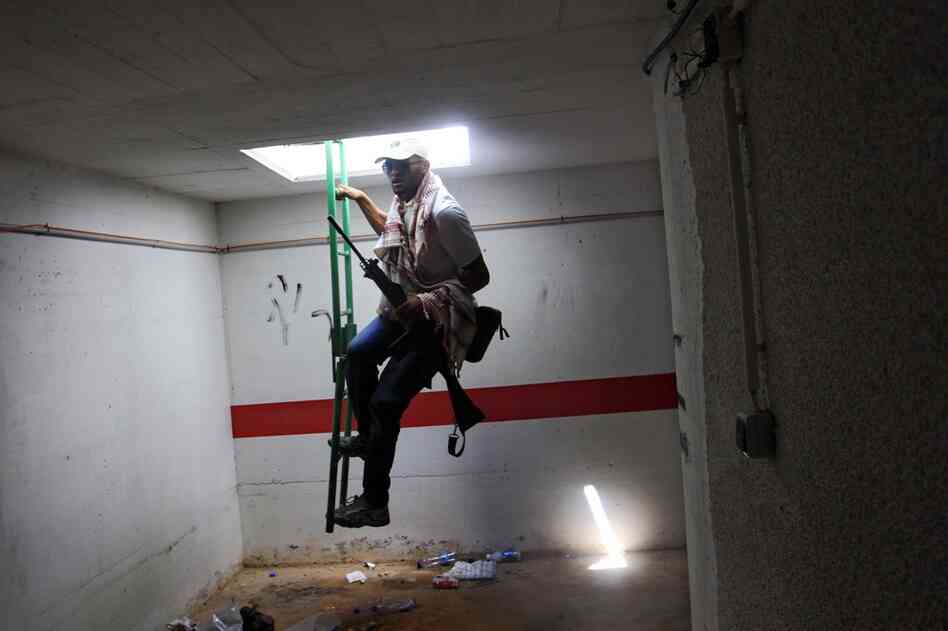 A rebel fighter enters a bunker of Moammar Gadhafi's main compound. Libya's rebel leadership has offered a $2 million bounty on Gadhafi's head. 