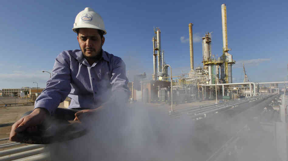 A Libyan oil worker at a refinery inside the Brega oil complex, in eastern Libya, on Feb. 26. Production at Brega has dropped by almost 90 percent amid the country's crisis because many employees have fled, and few ships are coming to the port. A Libyan oil worker at a refinery inside the Brega oil complex, in eastern Libya, on Feb. 26. Production at Brega has dropped by almost 90 percent amid the country's crisis because many employees have fled, and few ships are coming to the port.