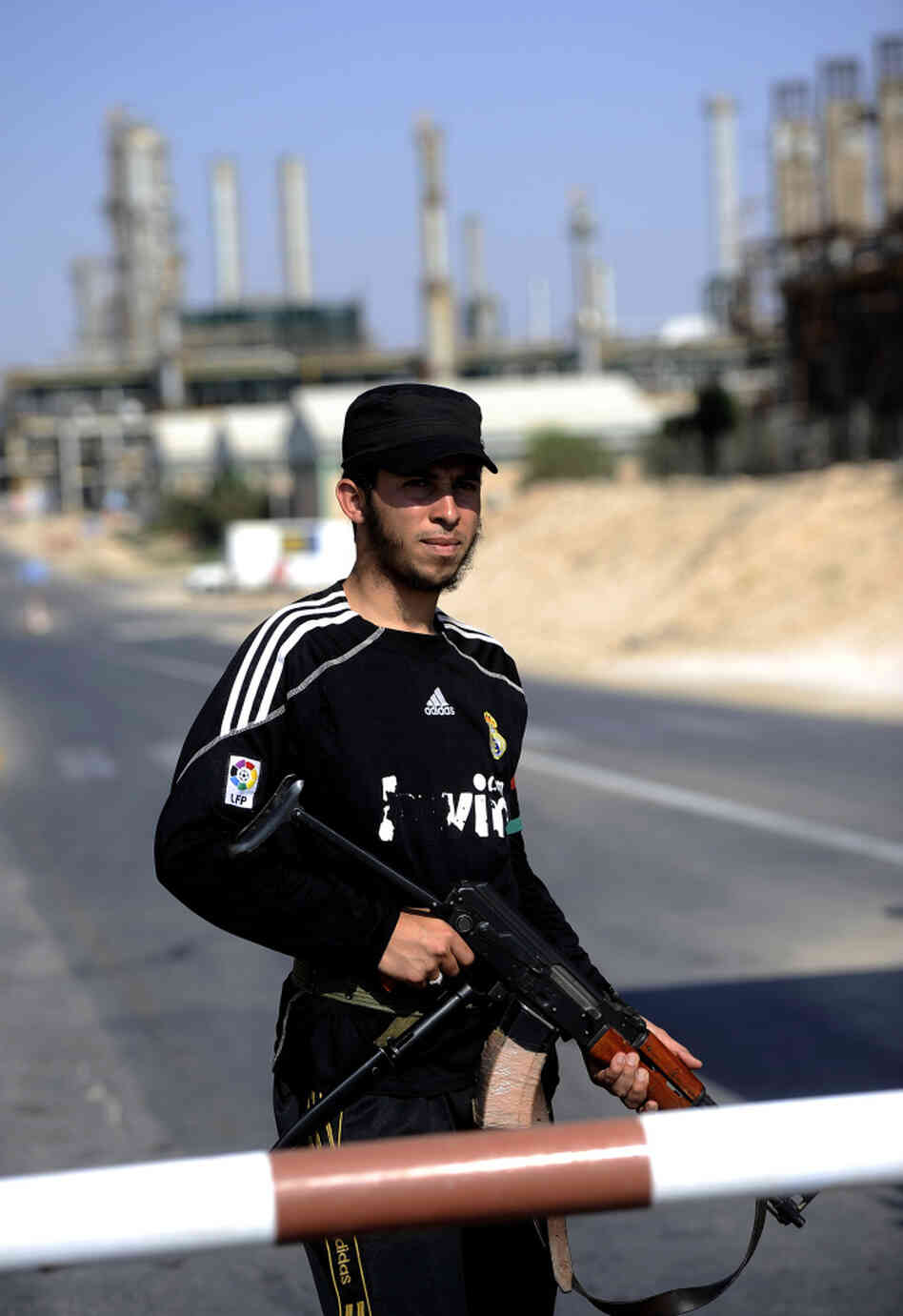 A Libyan rebel stands guard at the entrance to the Zawiya oil refinery, about 30 miles west of Tripoli, on Aug. 19. Rebels have taken complete control of the key oil refinery. Before the conflict, Libya supplied 2 percent of the world's oil, but restarting oil field operations won't be a simple task. A Libyan rebel stands guard at the entrance to the Zawiya oil refinery, about 30 miles west of Tripoli, on Aug. 19. Rebels have taken complete control of the key oil refinery. Before the conflict, Libya supplied 2 percent of the world's oil, but restarting oil field operations won't be a simple task.