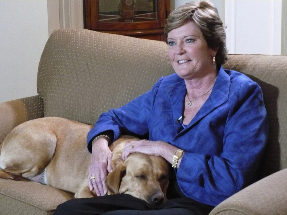 Tennessee women's basketball coach Pat Summitt sits with her dog at her home in Knoxville, Tenn. Summitt plans to coach "as long as the good Lord is willing" despite recently being diagnosed with early onset dementia.