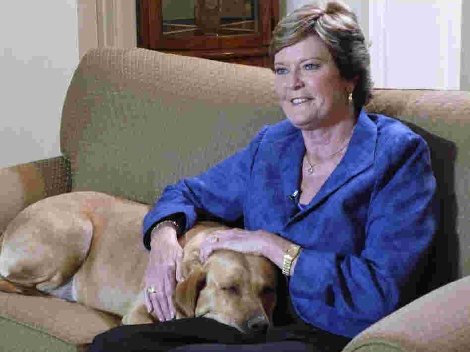 Tennessee women's basketball coach Pat Summitt sits with her dog at her home in Knoxville, Tenn. Summitt plans to coach "as long as the good Lord is willing" despite recently being diagnosed with early onset dementia.