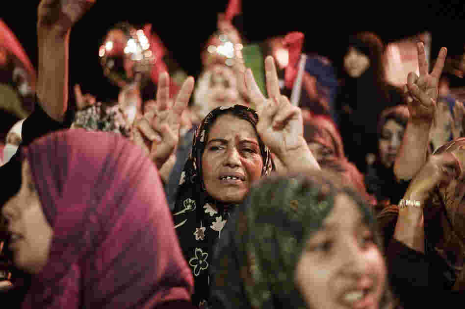 A Libyan woman flashes the V-sign for victory as people celebrate the end of Gadhafi's 42-year rule in the eastern city of Benghazi. 