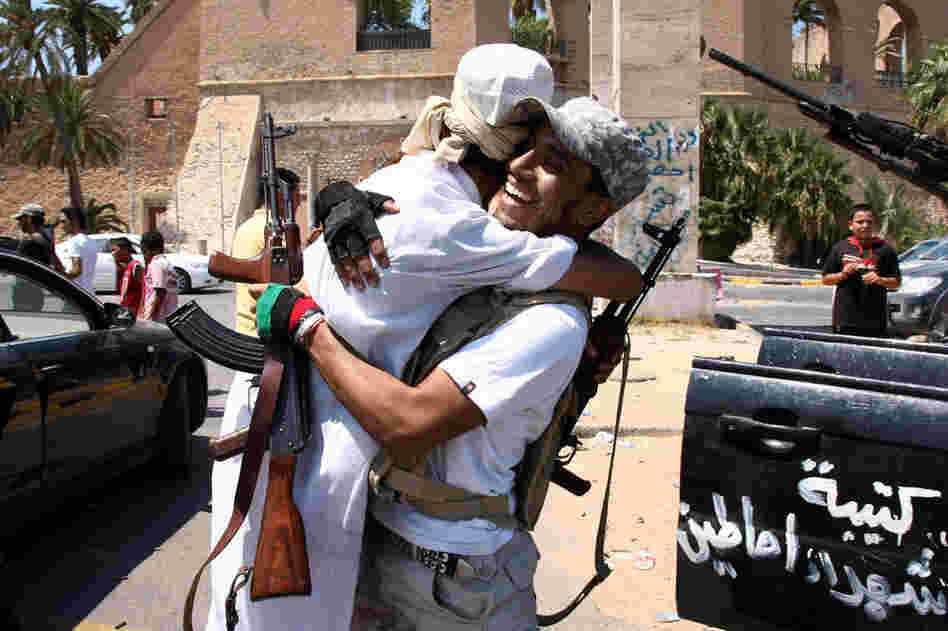 Libyan rebel fighters celebrate in the newly named Martyr's Square, formerly known as Green Square, in Tripoli. 