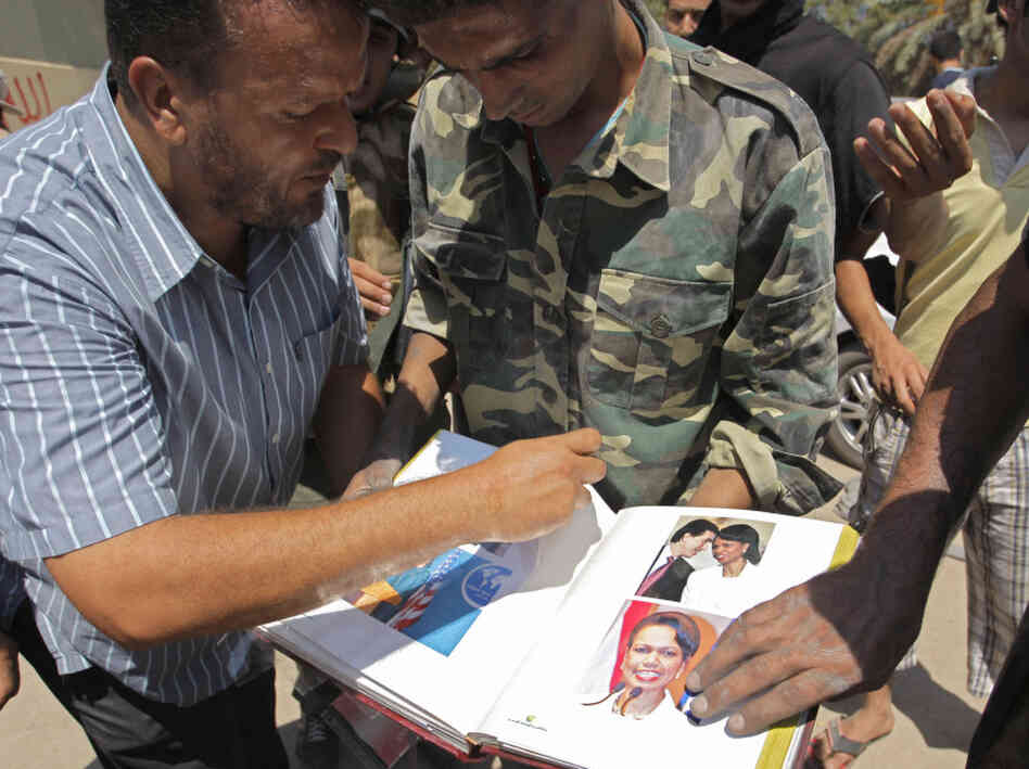 On Wednesday, opposition fighters looked through an album they found inside Moammar Gadhafi's compound in Tripoli. It includes photos of former Secretary of State Condoleezza Rice.