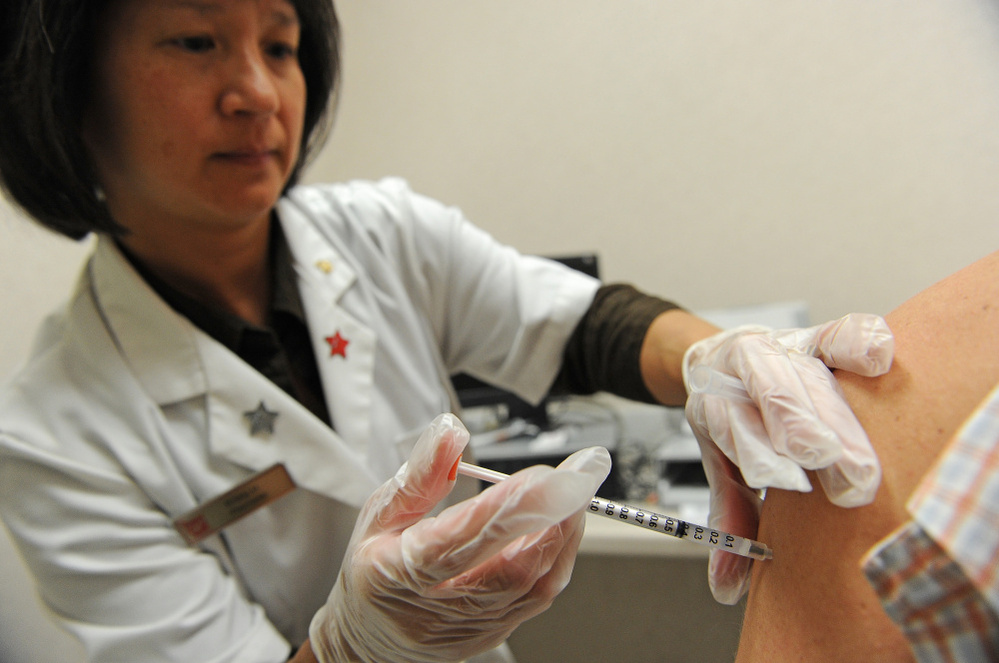 Pharmacist Kristy Hennessee administers a vaccination against whooping cough at a Walgreen's pharmacy in Pasadena, Calif. last year.