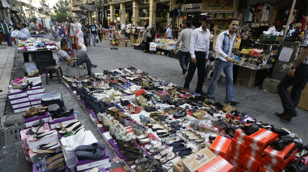 Syrian street vendors display their goods in downtown Damascus on Tuesday. Syria's economy was hit hard initially by the anti-government uprising. It has bounced back, but now the U.S. is urging the European Union to join in banning imports of crude oil from Syria.
