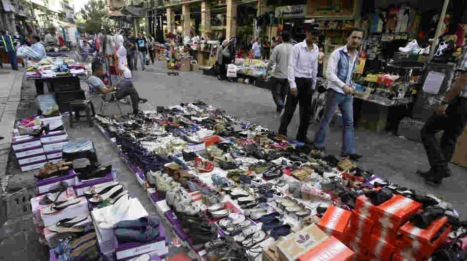 Syrian street vendors display their goods in downtown Damascus on Tuesday. Syria's economy was hit hard initially by the anti-government uprising. It has bounced back, but now the U.S. is urging the European Union to join in banning imports of crude oil from Syria.