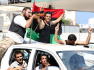 Rebel fighters celebrate their gains in Tripoli on Friday. Rebel fighters celebrate their gains in Tripoli on Friday.