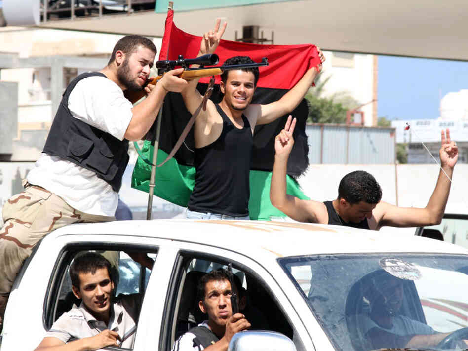 Rebel fighters celebrate their gains in Tripoli on Friday. Rebel fighters celebrate their gains in Tripoli on Friday.