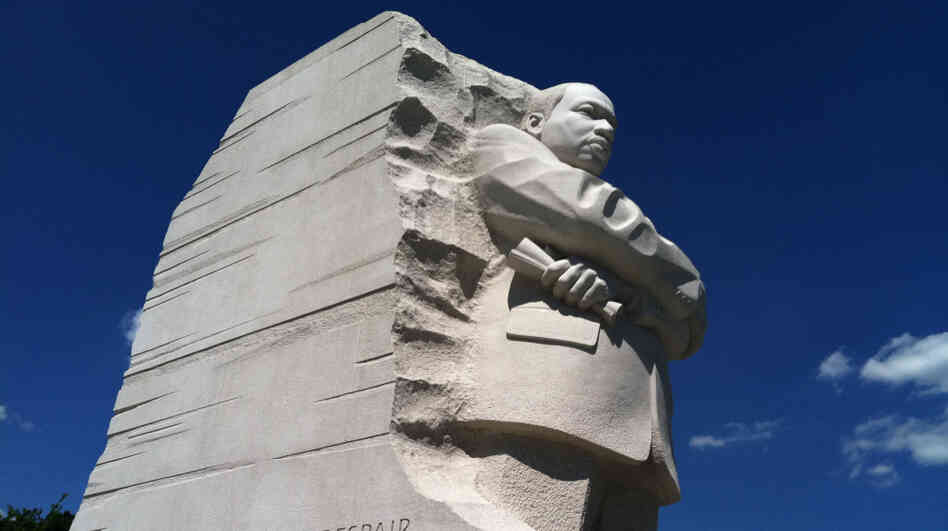 The statue shows King emerging from a stone extracted from a mountain.