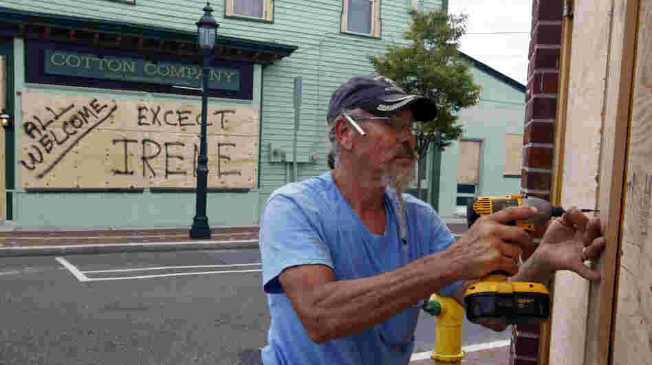 Marvin Hardy drives screws into a sheet of plywood on Washington Mall in Cape May, N.J., on Friday, as he  boards up storefronts in preparation for Hurricane Irene. Mandatory evacuations were under way  affecting nearly 1 million residents and visitors in Cape May County, coastal Atlantic County and Long Beach Island, N.J.