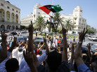 Libyans celebrate after prayers at a mosque next to the newly named Martyrs Square in Tripoli on Friday. Libyans celebrate after prayers at a mosque next to the newly named Martyrs Square in Tripoli on Friday.