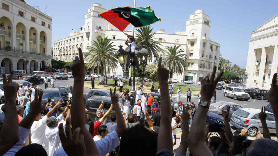 Libyans celebrate after prayers at a mosque next to the newly named Martyrs Square in Tripoli on Friday. Libyans celebrate after prayers at a mosque next to the newly named Martyrs Square in Tripoli on Friday.