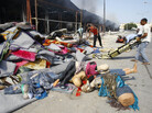 Libyans removed items from a clothes shop Friday after an intense battle in the Abu Salim district of Tripoli. Hundreds of miles to the east, loyalist troops battled rebels advancing toward the city of Sirte. Libyans removed items from a clothes shop Friday after an intense battle in the Abu Salim district of Tripoli. Hundreds of miles to the east, loyalist troops battled rebels advancing toward the city of Sirte.