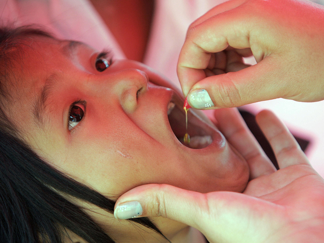 A child receives a dose of vitamin A in Guatemala City.