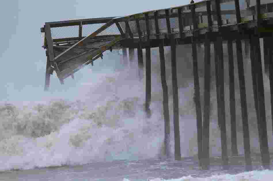 Large waves pound a pier Sunday morning in Ocean City, Md. 