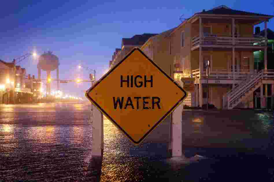 A sign stays just above the water in Ocean City, Md., on Saturday. 