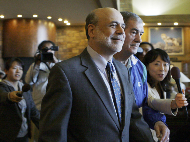 Federal Reserve Chairman Ben Bernanke walks past reporters as he arrives at the economic policy symposium at Jackson Hole in Moran, Wyo., on Friday.