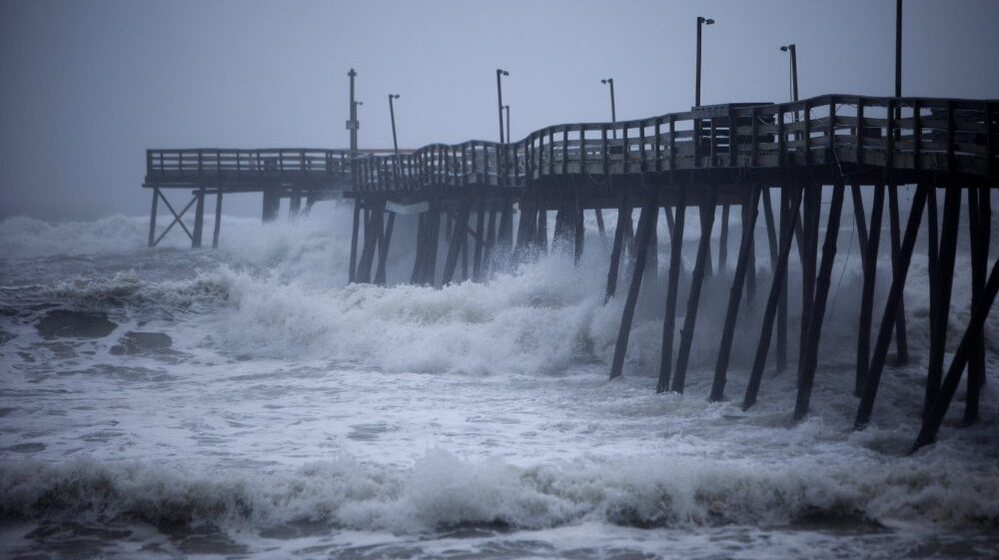 Waves crash into Avalon Pier as Hurricane Irene strikes the Outer Banks in Kill Devil Hills, N.C. earlier today.