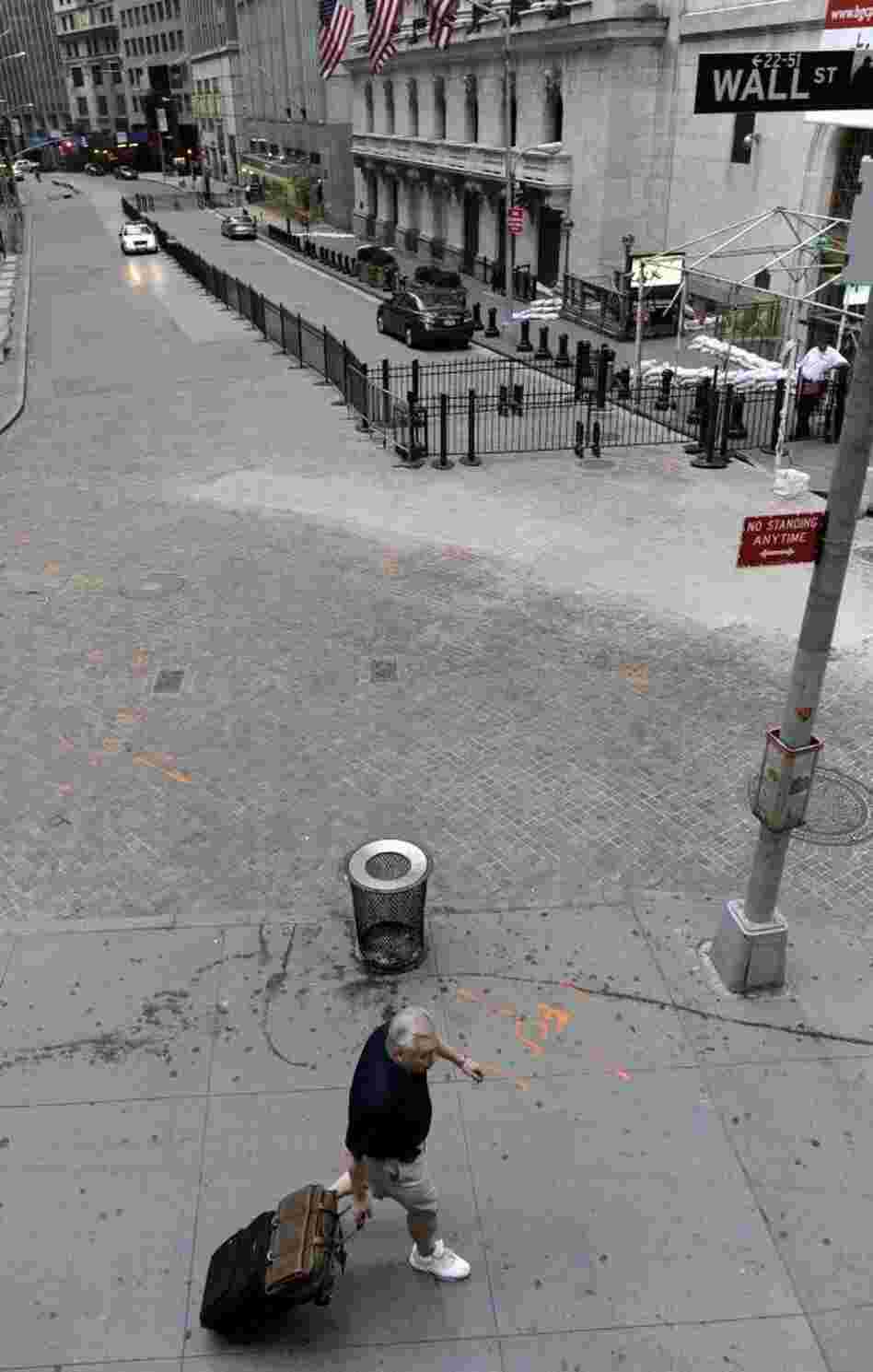 Earlier today, a man pulled his luggage up Wall Street — one of the low-lying areas — in Manhattan.