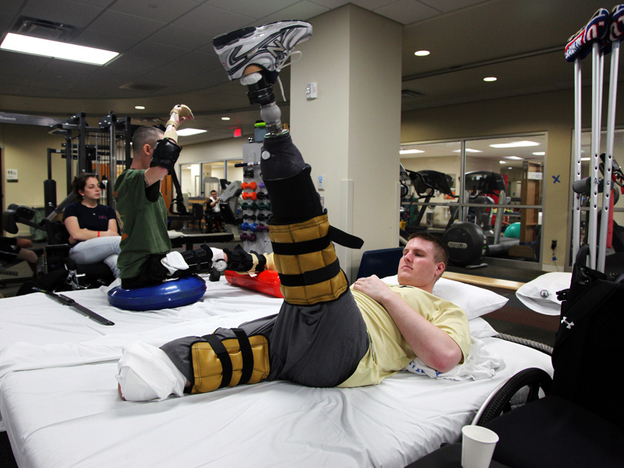 Tyson Quink exercises at the National Naval Medical Center in Bethesda, Md. Quink, a former college football player, lost both of his legs three months into his deployment to Afghanistan.