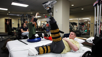 Tyson Quink exercises at the National Naval Medical Center in Bethesda, Md. Quink, a former college football player, lost both of his legs three months into his deployment to Afghanistan.