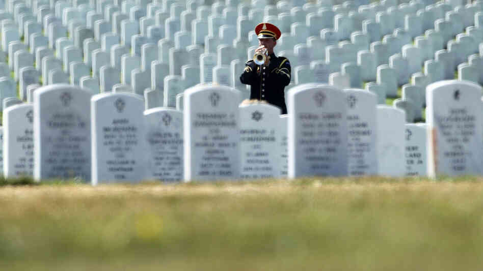 A bugler plays taps during an Aug. 9 funeral at Arlington National Cemetery in Arlington, Va. After reports revealed mishandling of remains at the cemetery, military officials are now working to reconcile the burial records of the 330,000 people laid to rest there. A bugler plays taps during an Aug. 9 funeral at Arlington National Cemetery in Arlington, Va. After reports revealed mishandling of remains at the cemetery, military officials are now working to reconcile the burial records of the 330,000 people laid to rest there.