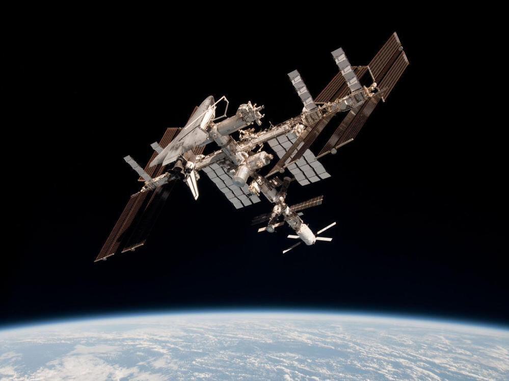 The International Space Station and the docked space shuttle Endeavour, flying at an altitude of approximately 220 miles, on May 23, 2011.