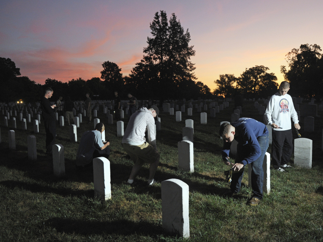 The sun rises over Section 15 at Arlington National Cemetery as soldiers from the Army Old Guard photograph headstones on Aug. 24. Their work is part of a task force to photograph and catalog nearly 220,000 grave markers and the columbarium niches of more than 43,000 sets of cremated remains at Arlington.
