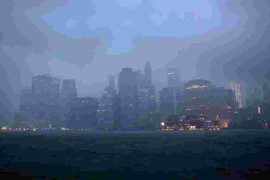 Lower Manhattan sits amid dark clouds as Irene bears down on New York early Sunday, bringing winds and rapidly rising seawater that threatened parts of the city. 