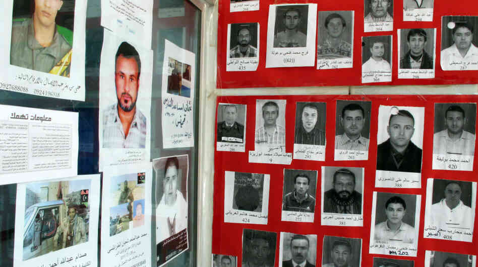 The walls of the Libyan Red Crescent office in Benghazi, Libya, shown here on Monday, are covered with photos of the missing. Some disappeared during Libya's revolution, but some have been missing for more than 10 years. Now, thousands released from Libya's prisons are being reunited with their families.