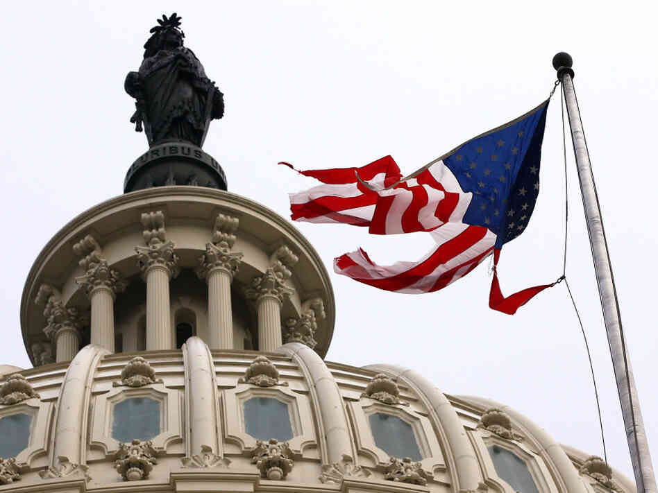 Irene's winds tore the flag that was flying in front of the U.S. Capitol on Sunday.