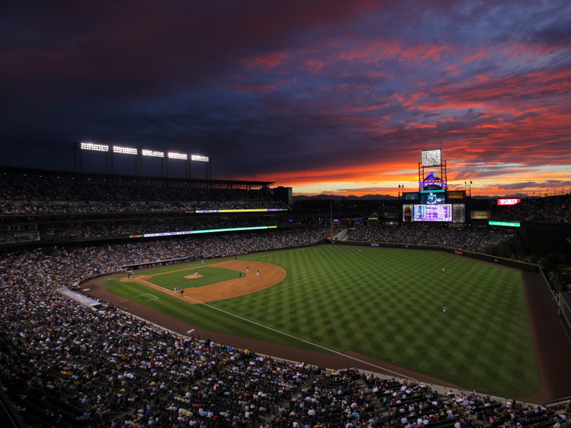 The sun sets over Coors Field in Denver. While summer nights are perfect for baseball, late-season games can get a little chilly.