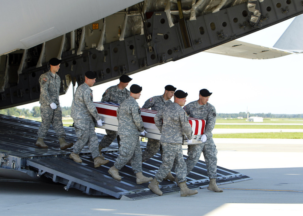An Army carry team moves a transfer case containing the remains of  Spc. Michael C. Roberts during a dignified transfer ceremony at Dover Air Force Base, Del., on Tuesday.