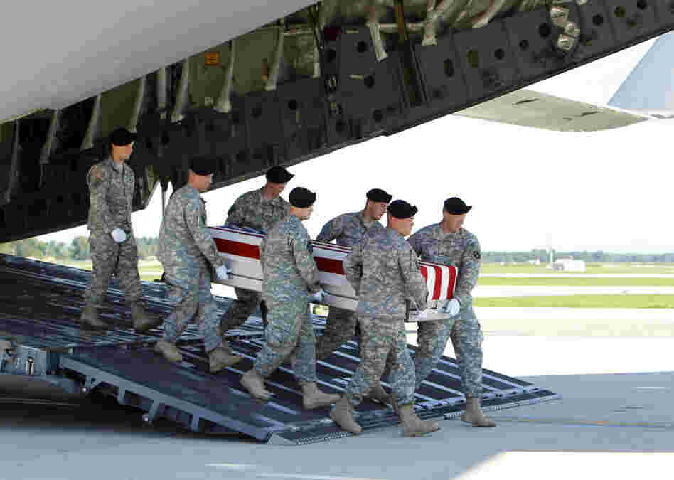 An Army carry team moves a transfer case containing the remains of  Spc. Michael C. Roberts during a dignified transfer ceremony at Dover Air Force Base, Del., on Tuesday.