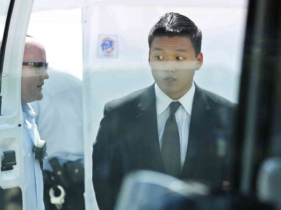 Former U.S. Army officer Dan Choi is led by a U.S. Park Police officer to a police van after being handcuffed and arrested during a protest over a proposed pipeline to bring tar sands oil to the U.S. from Canada, in front of the White House in Washington, Saturday, Aug. 20, 2011. Choi handcuffed himself to the White House in 2010 as well in protest of "Don't Ask, Don't Tell."
