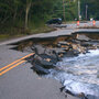Roaring Brook flows onto Route 73 in Keene, N.Y., on Tuesday.