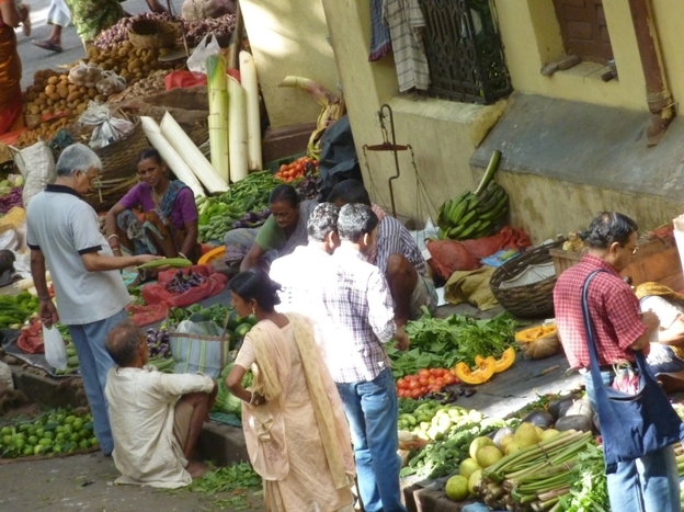 Shoppers pick out vegetables at a bazaar in Calcutta, India.