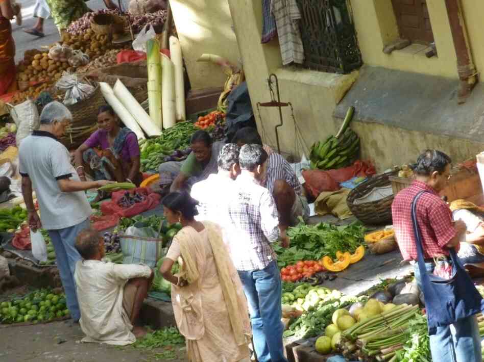 Shoppers pick out vegetables at a bazaar in Calcutta, India.
