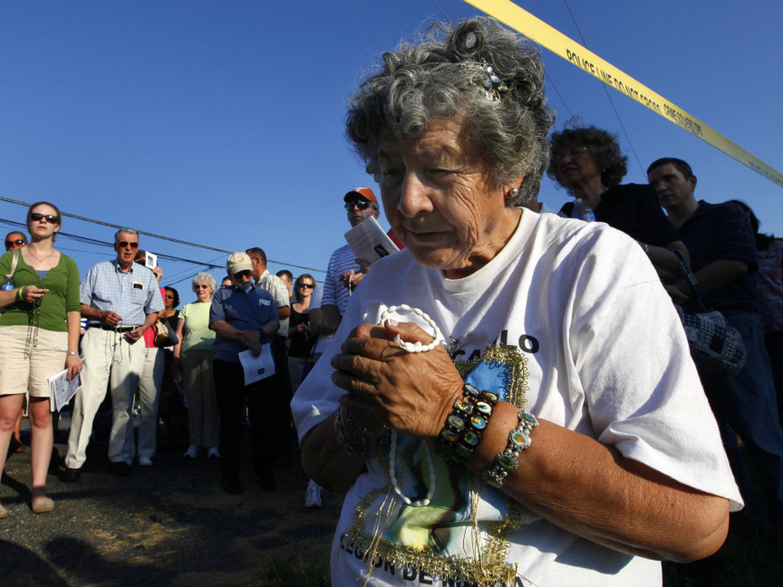 Anita Gisbert prays underneath police tape surrounding LeRoy Carhart's abortion clinic in Germantown, Md. in July. The Justice Department has increased enforcement of laws that prevent protesters from blocking access to clinics.