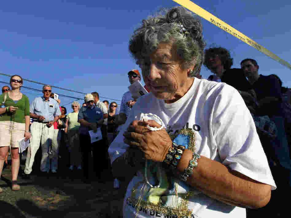 Anita Gisbert prays underneath police tape surrounding LeRoy Carhart's abortion clinic in Germantown, Md. in July. The Justice Department has increased enforcement of laws that prevent protesters from blocking access to clinics.