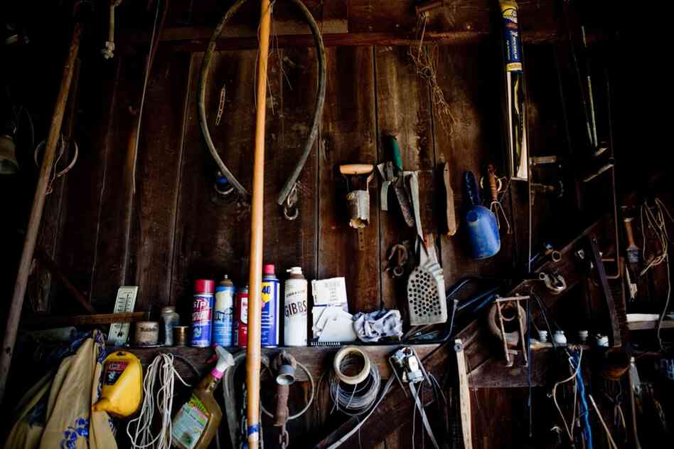 Farm tools line the walls of Bowling's barn. He prides himself on keeping his old tractor repaired and tending to his customers' needs.